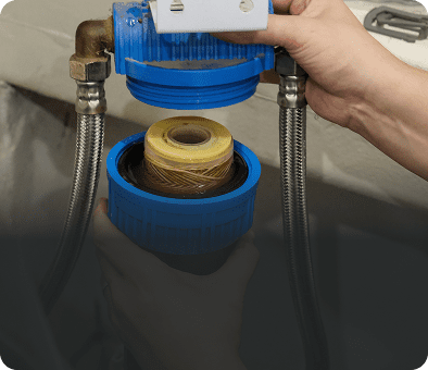 Hands installing a water filter cartridge.
