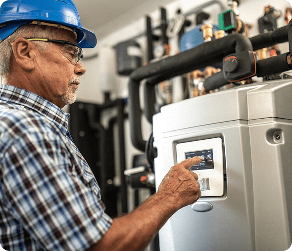Man operating industrial machine with touchscreen.