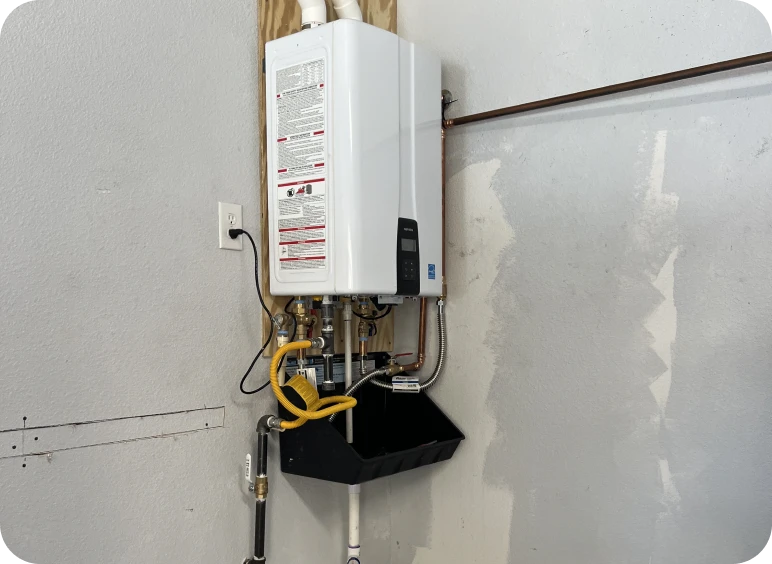 Wall-mounted tankless water heater with pipes.