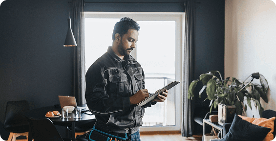 Man taking notes in a modern room.