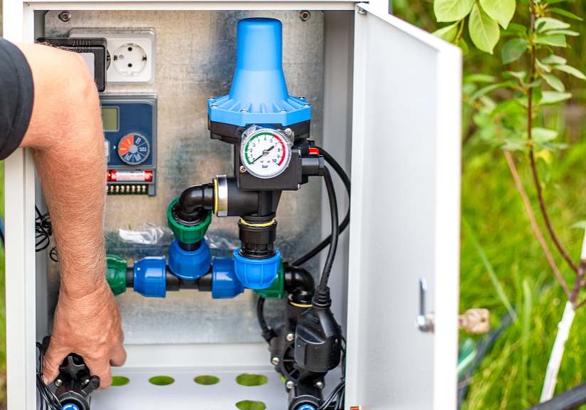 Person adjusting irrigation control system.